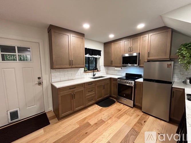 A kitchen with wooden cabinets and stainless steel appliances.