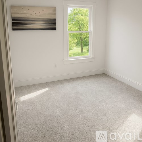 A room with a window showing a tree outside.