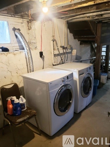 A washing machine and dryer are in a basement.
