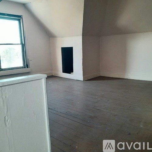 A room with wooden floors and a window.
