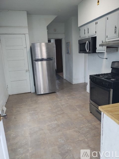 A kitchen with a stainless steel refrigerator and oven.
