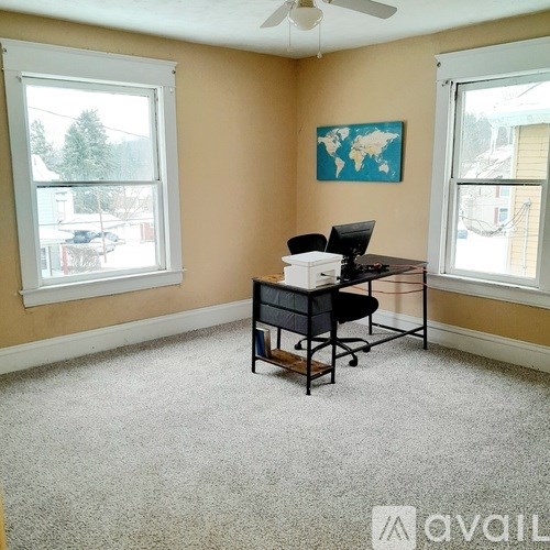 A room with a desk and a chair in it.