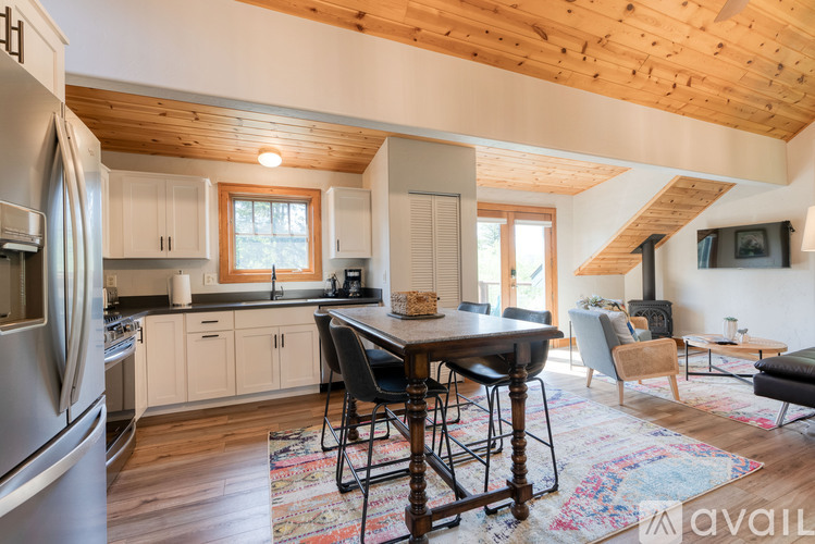 A kitchen with wooden cabinets and a stainless steel refrigerator.