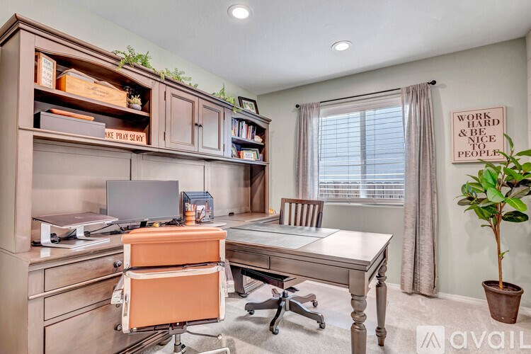 A well-organized office with a desk, chair, and shelves with various items.
