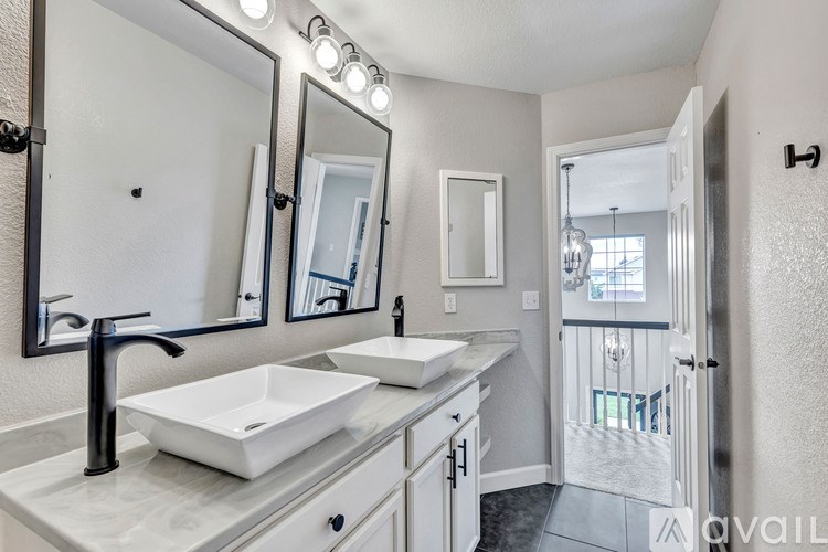 A bathroom with a sink, mirror, and lights.