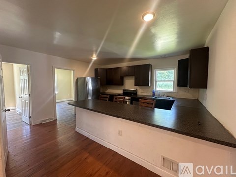 A kitchen with a bar counter and cabinets.