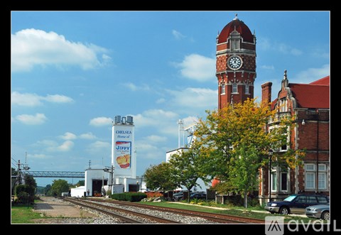 A train station with a clock tower and a Jiffy Lube sign.