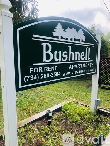 A sign for Bushnell apartments for rent is displayed.