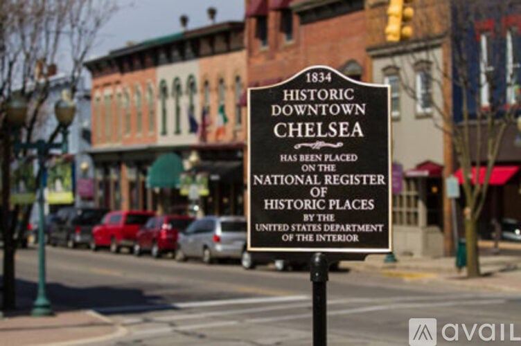 A sign in front of a building that says Historic Downtown Chelsea.