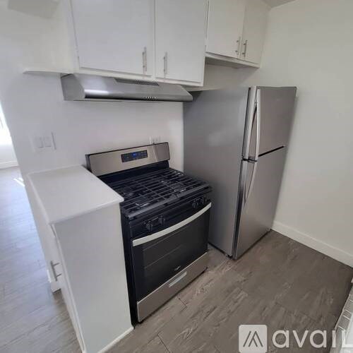 A kitchen with a stove, oven, and refrigerator.