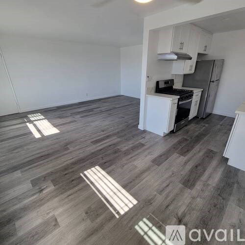 A kitchen with a refrigerator, stove, and oven.