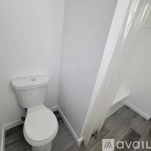 A white toilet in a small bathroom.