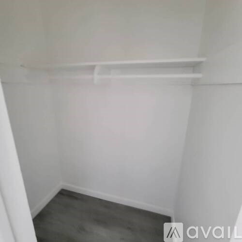 A white shelf in a room with white walls.