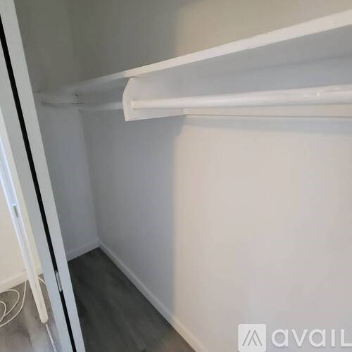 A white refrigerator with a white shelf inside.