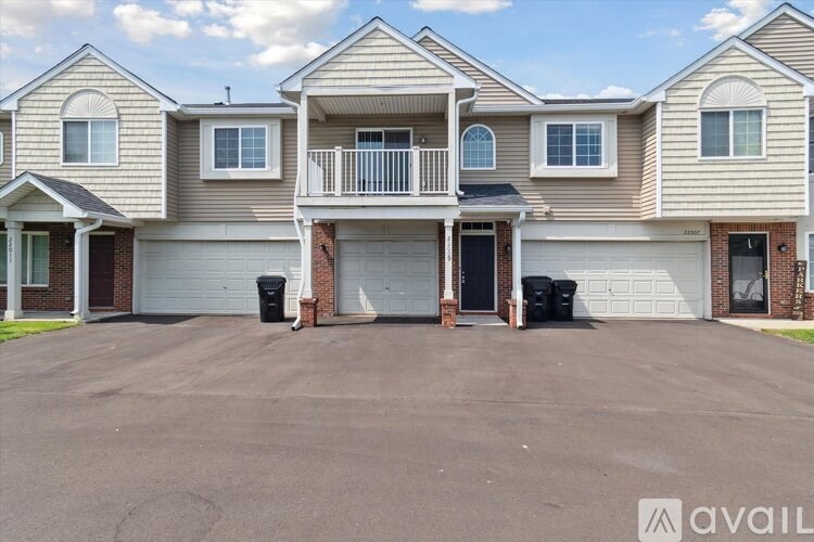 A row of houses with the first one having a balcony.