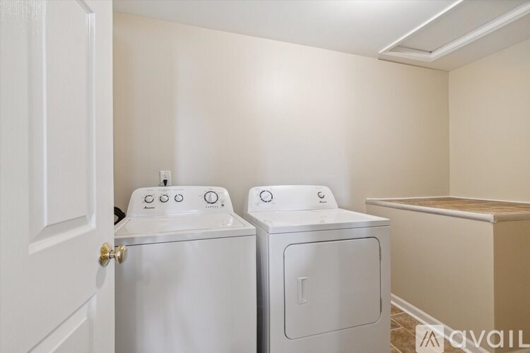 A white washer and dryer in a small laundry room.