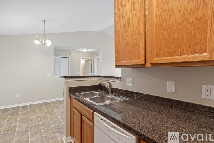 A kitchen with wooden cabinets and a granite countertop.