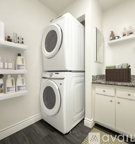 A white washing machine and dryer in a small laundry room.