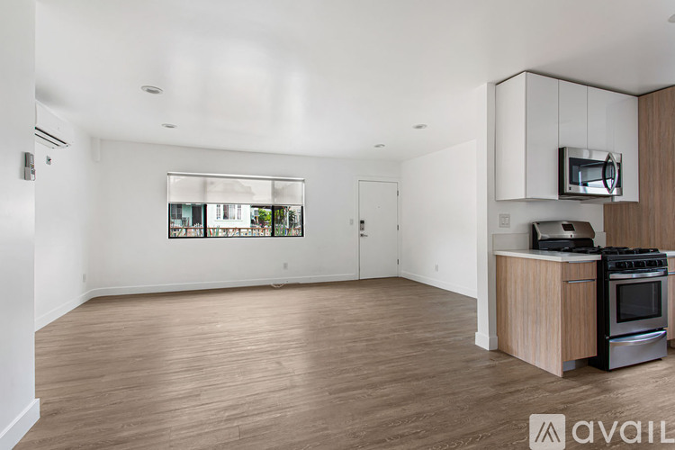 A kitchen area with a stove and microwave.