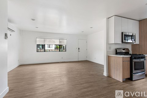 A kitchen area with a stove and microwave.