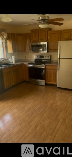 A kitchen with wooden cabinets and a white refrigerator.
