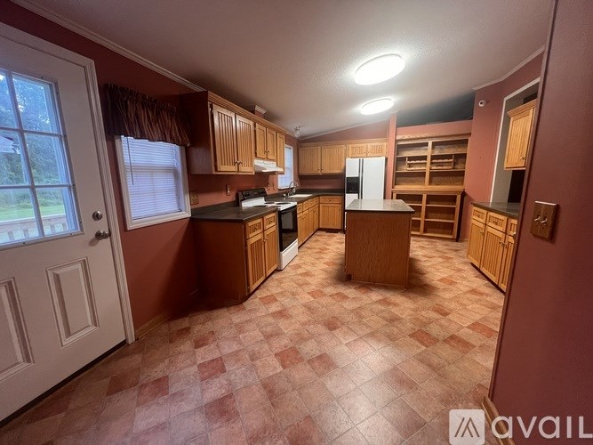 A kitchen with brown cabinets and a checkered floor.