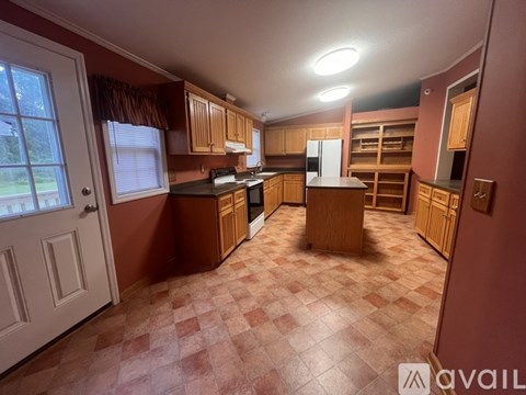 A kitchen with brown cabinets and a checkered floor.