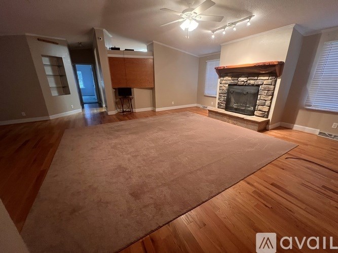 A kitchen with pink walls and a white door.