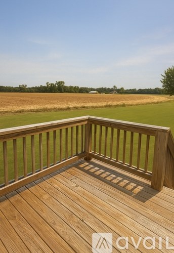 A living room with a fireplace and a brown rug.