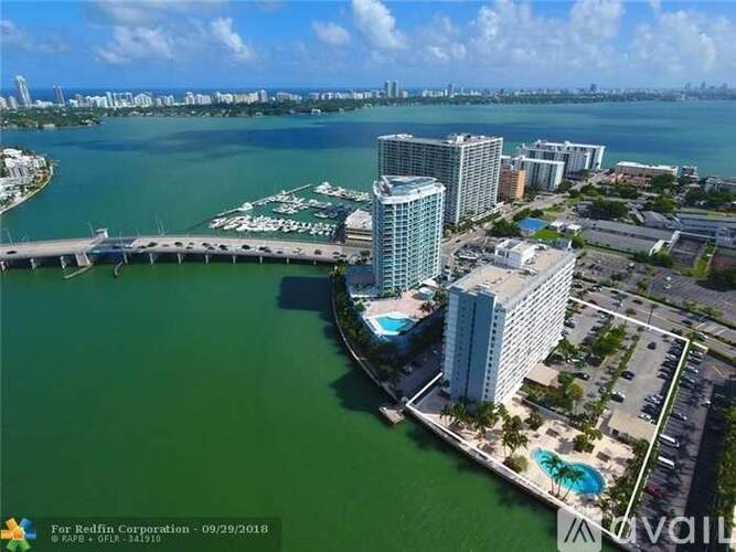 A large body of water with a dock and buildings in the background.