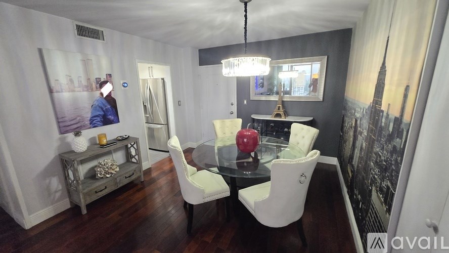 A modern dining room with a wooden table and white chairs.