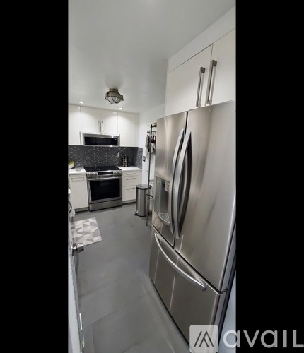 A modern kitchen with a stainless steel refrigerator.