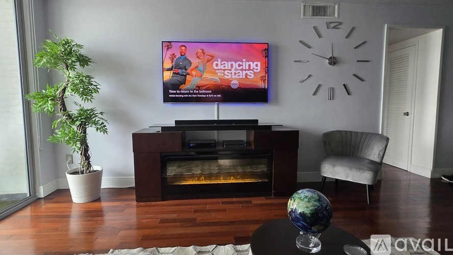 A city skyline is visible in the distance with a cloudy sky above.