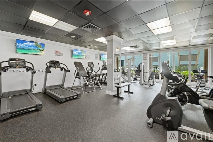 A gym with treadmills, exercise bikes, and other equipment.