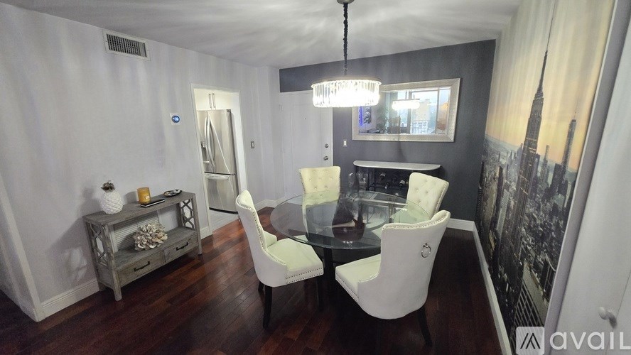 A living room with a flat screen TV mounted on the wall and a large clock.