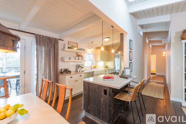 A kitchen with a table and chairs in front of it.