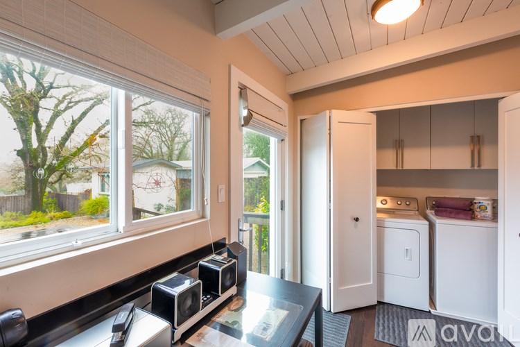 A kitchen area with a washer and dryer in the background.