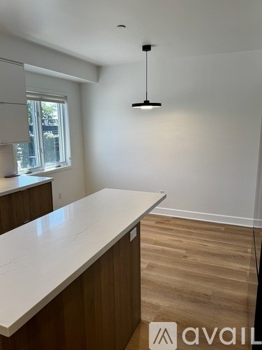 A kitchen with wooden cabinets and a white countertop.