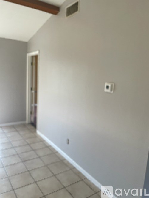 A room with a tiled floor and a door.