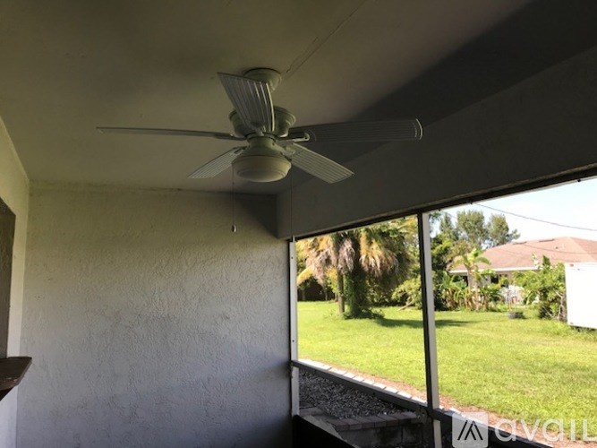 A ceiling fan is mounted on a white ceiling.