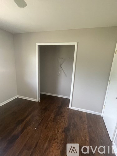 A room with a wooden floor and a white door.
