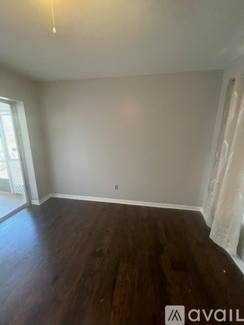 A room with wooden floors and white walls.