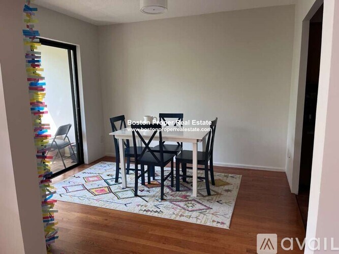 A dining room with a table and chairs.