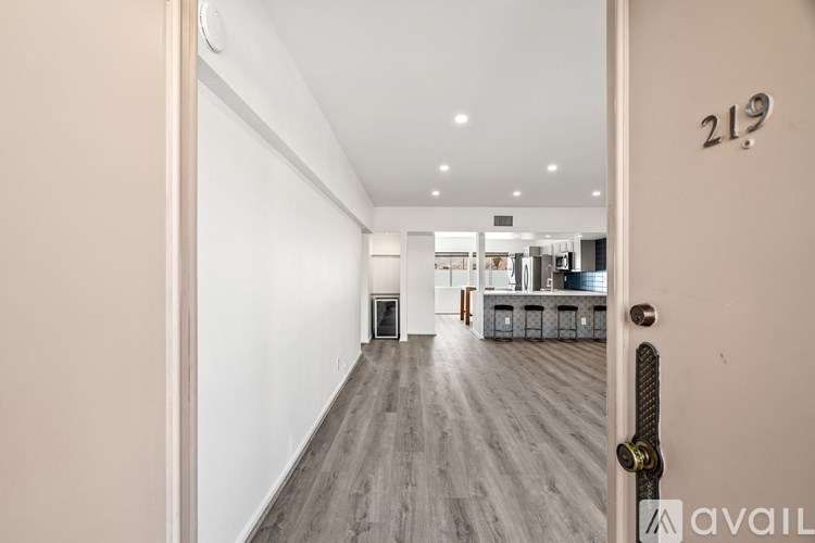 A hallway with a door numbered 219 and a sign that says "available".