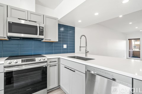 A modern kitchen with white cabinets and a stainless steel dishwasher.