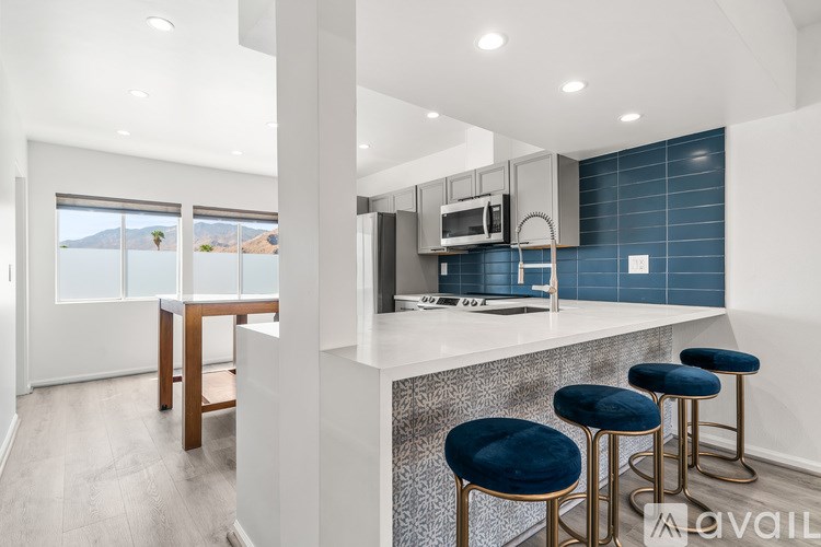 A modern kitchen with a bar stool and a countertop.