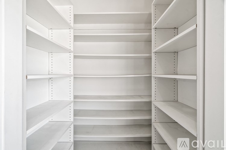 Empty white shelves with no items on them.