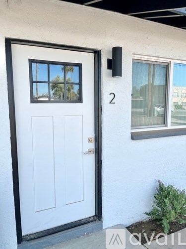 A white door with a black frame and a window above it.