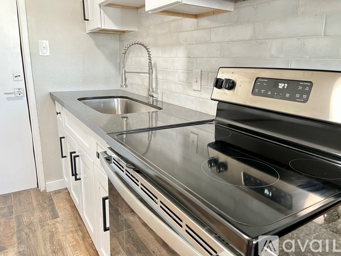 A modern kitchen with a stainless steel oven and a digital display on it.