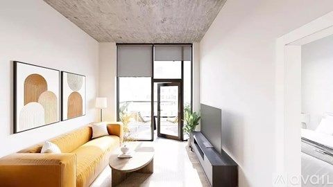 A living room with a yellow couch and a coffee table.